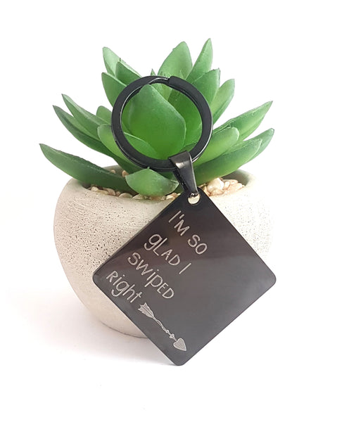 This engraved keyring on a square base reads 'I'm so glad I swiped right' and features an arrow, allowing you to proudly display your successful dating app match. No more worrying about meeting a potential lunatic - this gift is a perfect reminder of your good decision-making skills.